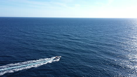 Boat-in-open-sea-Porquerolles-coast-aerial-shot-blue-sky